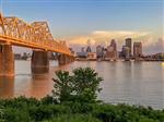 Bridge in foreground with Louisville city skyline 